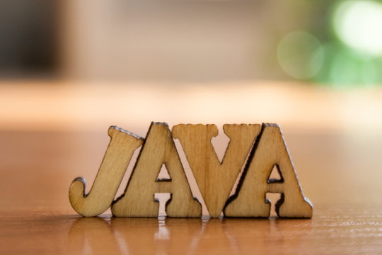 The word 'java' made of wooden letters. wood inscription on table