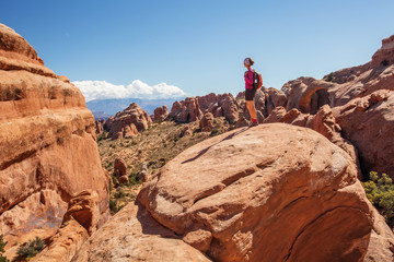 Hiker rests in Arches National park in Utah, USA