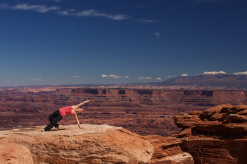 Woman meditating doing yoga in Canyonlands National park in Utah, USA