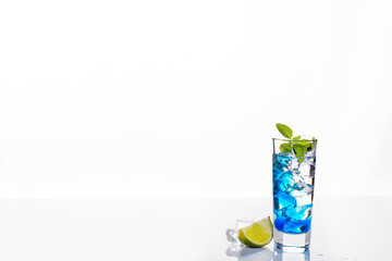 cocktail glass with blue alcoholic drink , close-up isolated on white.