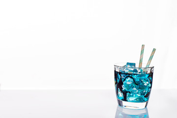 cocktail glass with blue alcoholic drink , close-up isolated on white.