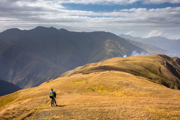 Fototapeta premium Mountain biker is travelling in the highlands of Tusheti region, Georgia