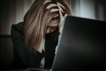 Asian woman working in office,young business woman stressed from work overload with a lot file on the desk,Thailand people