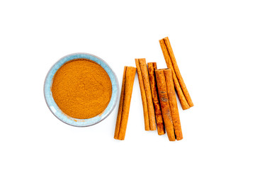 Cinnamon seasoning. Sticks and powder on white background top view copy space