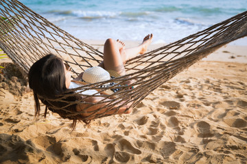 Happy woman relaxing in hammock