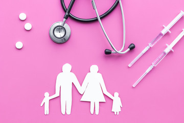 Vaccination as way to save healthy family. Syringe with colored vaccine near silhouette of family on pink background top view