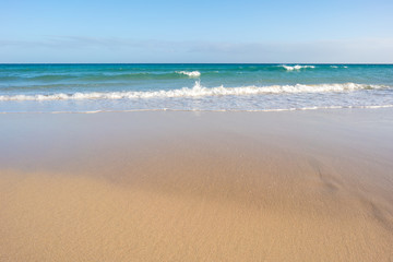 Fototapeta na wymiar closeup of sand on beach and blue summer sky