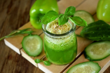 Green smoothie in a glass jar sprinkled with brans decorated with basil