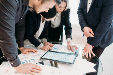 business meeting. problem solving, issue management. troubleshooting. communication, information exchange. executives discussing company results reading papers with graphical data