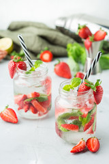 Alcohol cocktail mojito lemonade with rum, soda, strawberry and basil