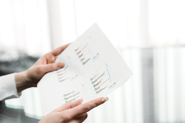 business documents graphs. hands holding papers. report statistics data analysis. office workplace