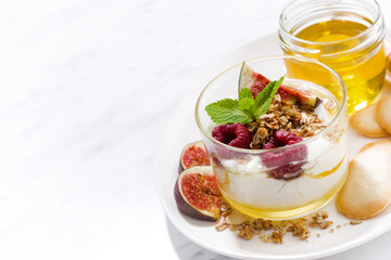 sweet yogurt with honey and fresh figs on white background