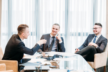 work break. business team of company executives laughing and joking during office meeting. friendship communication concept