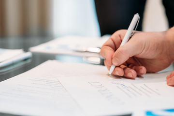 man hand signing contract closeup. business partnership and cooperation. deal closing and legal...