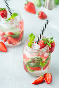 Alcohol cocktail mojito lemonade with rum, soda, strawberry and basil