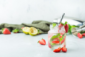 Alcohol cocktail mojito lemonade with rum, soda, strawberry and basil