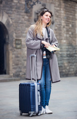 Blond beautiful girl holding brochure