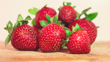 Red strawberry lying on a wooden table