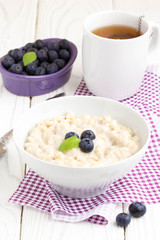 Oatmeal porridge with blueberries, tasty and healthy breakfast