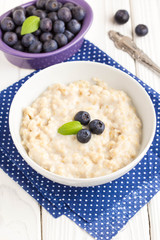 Oatmeal porridge with blueberries, tasty and healthy breakfast