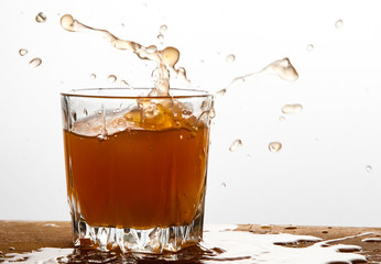 Grapefruit juice splash in glass studio isolated on white background