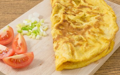 Thai Omelette with Tomatoes and Scallion on Cutting Board