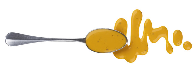 Honey mustard sauce. Splashes and spilled salad dressing with spoon isolated on white background....