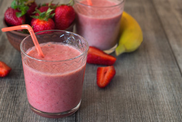 Strawberry milkshake with berries and banana in the glass jar