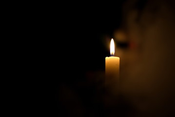 Candle in the dark. Smoke from a candle.