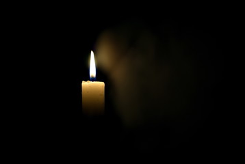 Candle in the dark. Smoke from a candle.