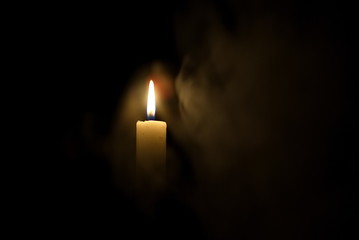 Candle in the dark. Smoke from a candle.