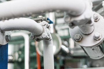 Two metal pipelines covered with frost layer.