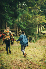 stylish loving couple is running to the hill