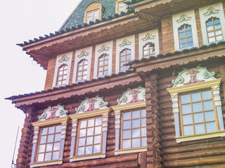 Fototapeta premium wooden log house facade against cloudy sky background