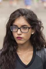 portrait of a brunette girl, with long hair and glasses