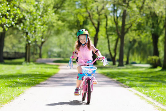 Child on bike. Kids ride bicycle. Girl cycling.