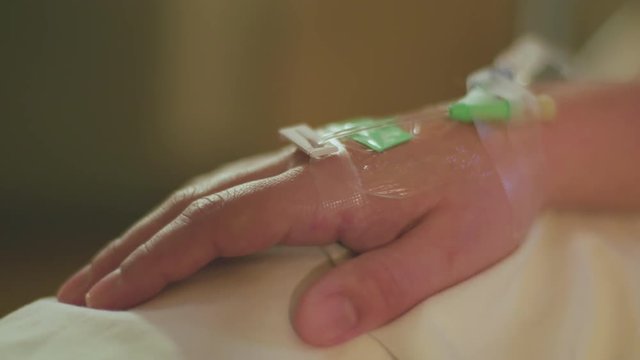 Female Hospital Patient Right Hand IV Intravenous Fluid Drip Tube Implanted in Vein For Drug Delivery During Caeserean Birth Surgery Medical Health Problems Concept