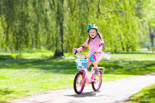 Child on bike. Kids ride bicycle. Girl cycling.