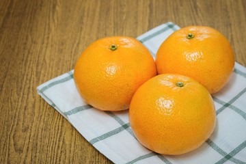 Three Ripe Oranges on A Wooden Table