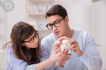 Two medical students studying in classroom