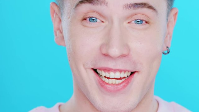Close-up face of a boy with blue eyes. Range of positive emotions. Facial expression