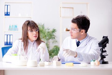Fototapeta premium Two lab doctor testing food products