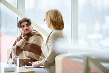 One of refugees in need listening to social worker recommendations during session in support center