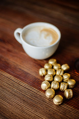 Cappuccino and golden macaroons.