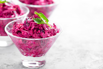 Beet salad. Salad of boiled beet. Beetroot salad with prune, walnuts and sour cream on white background