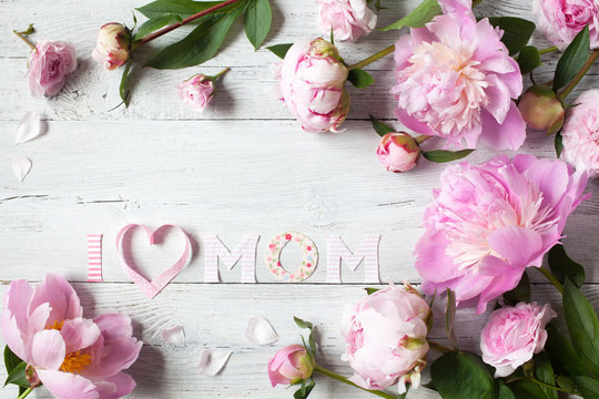 Background to Mother's Day with congratulations and pink peonies