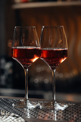 two glasses of red wine at the bar in the restaurant.