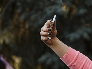Happy young woman making selfie photo. hand with phone