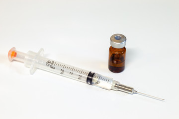 Medical Syringe and a vial of an intravenous drug on a white background