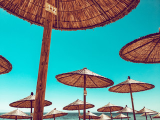 The beach umbrellas against the blue sky, sun parasols, thatched parasols, Kassandra, Greece.